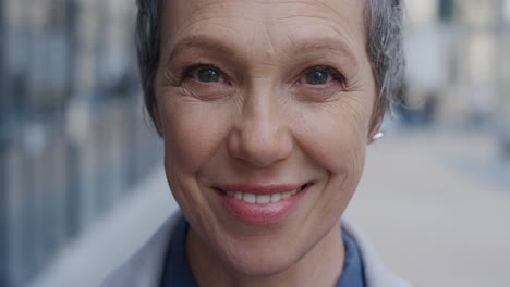 close-up-portrait-happy-mature-business-woman-smiling-enjoying-successful-urban-lifestyle-in-city-slow-motion-aging-beauty