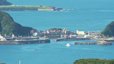 zoomed panoramic panning shot capturing the beautiful landscape of shen'ao fishing harbor from jiufen mountain town at daytime, ruifang district, new taipei city, taiwan