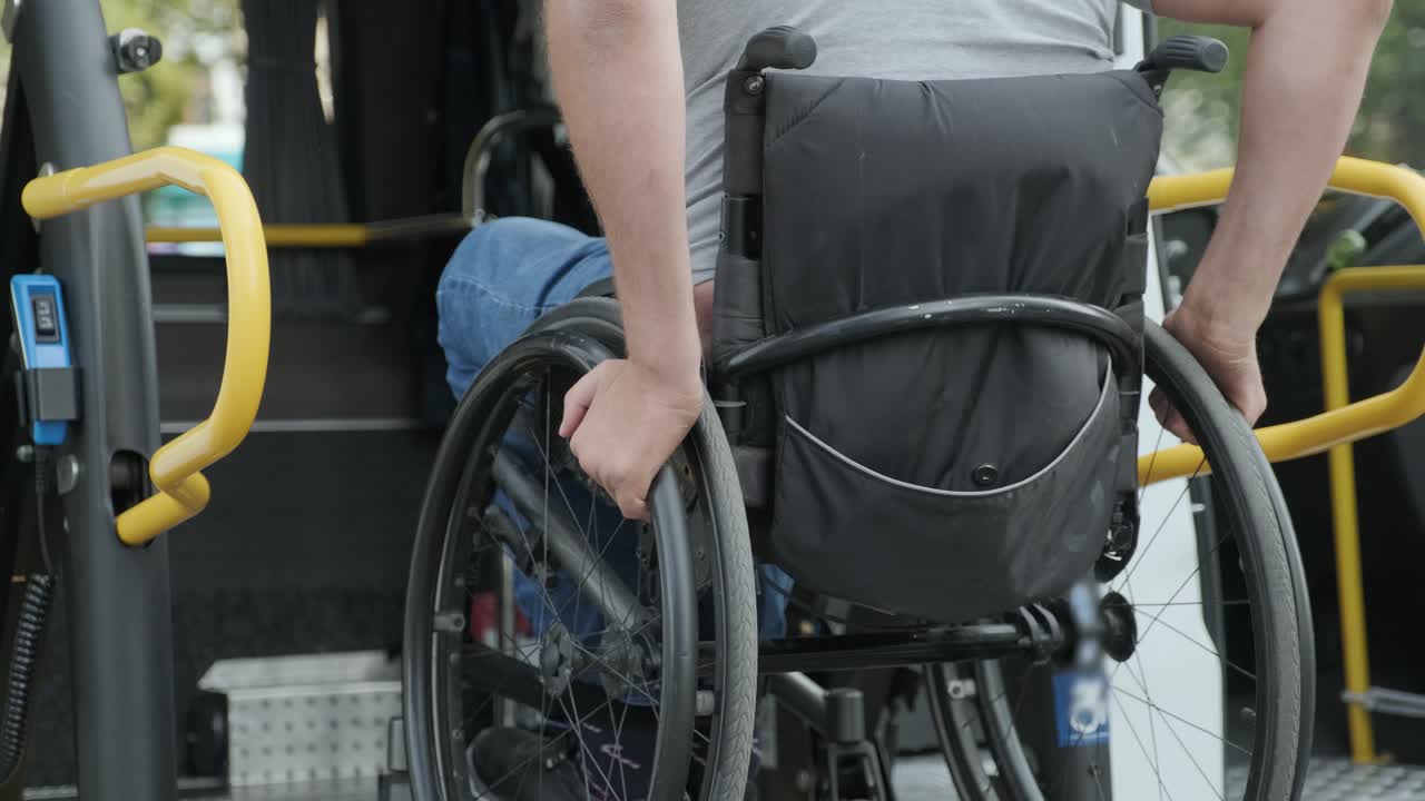 장애인을 위한 차량의 엘리베이터에 체어에 앉아 있는 사람. 장애인을 위한 리프팅 장비 - 차량 근처에 있는 체어를 타고 있는 사람