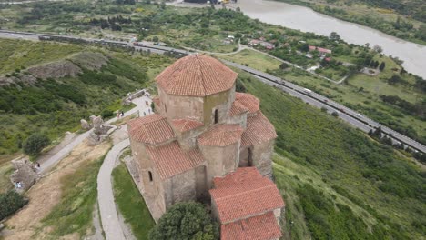 Aerial-shot-of-Jvari-church-Mtskheta-Georgia-river-city-mountains-meadows-forest