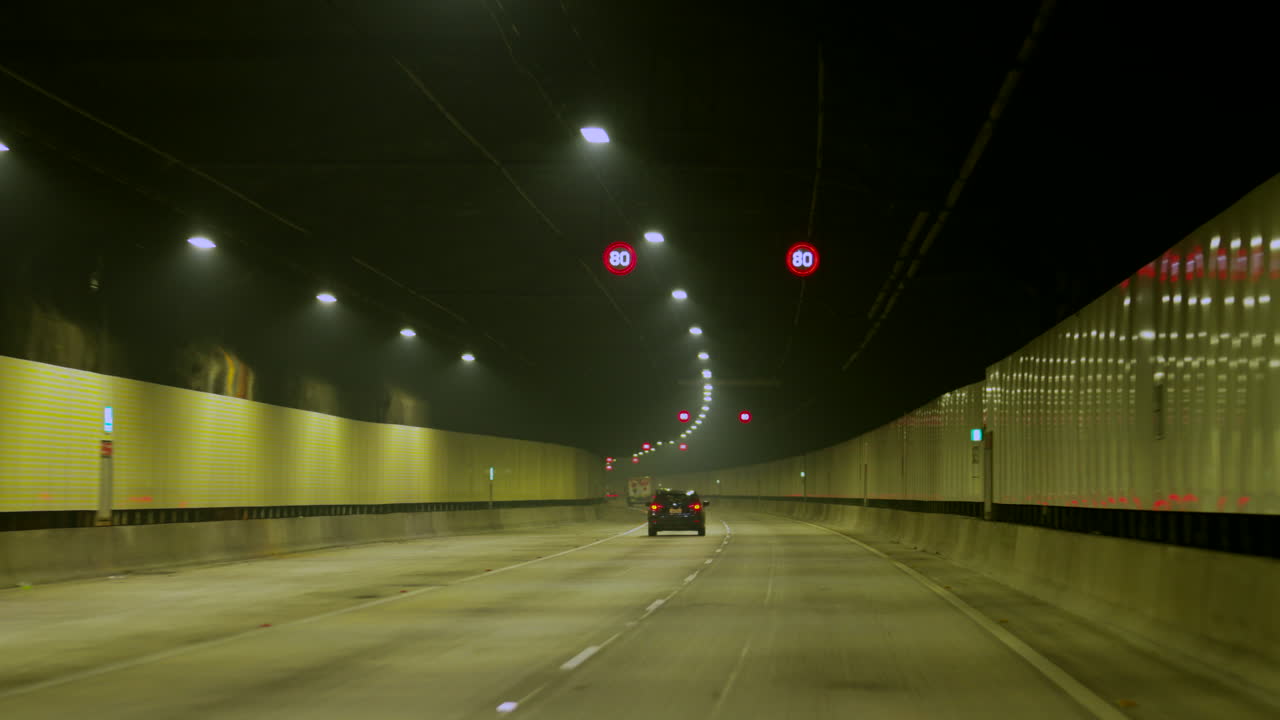 POV car Driving through a long tunnel, Sydney Australia