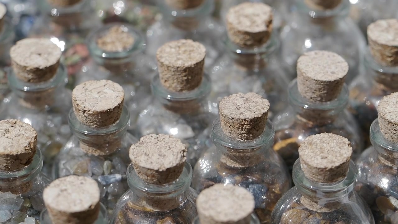 Small Glass Bottles Filled with Colorful Stones and Cork Stoppers