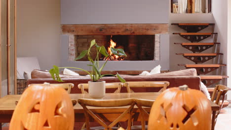 cozy living room with carved pumpkins and fireplace, warm autumn atmosphere, at home, halloween time