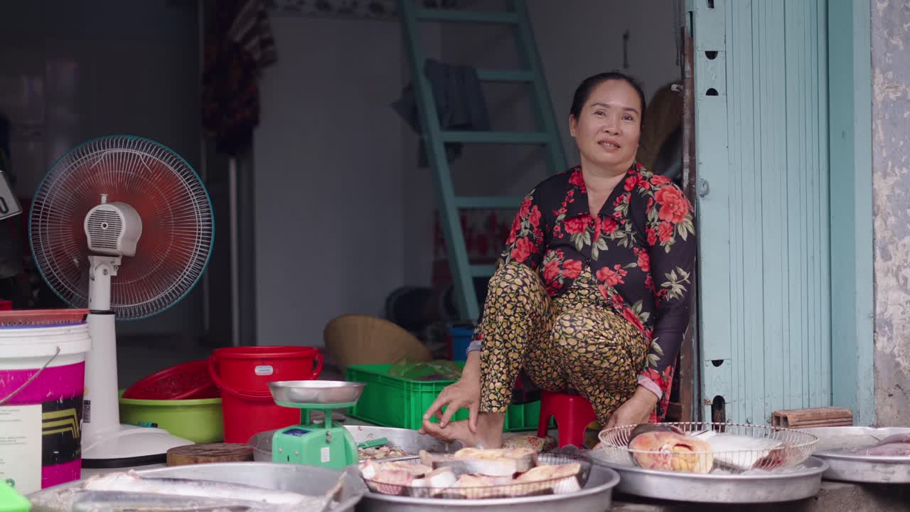 Woman selling fish at a market