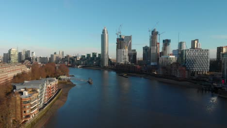 falling drone shot over thames river towards the tower vauxhall london