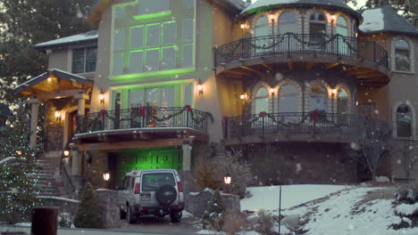 pan down to green lit house at christmas