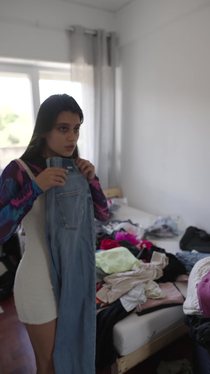 Woman getting dressed in a messy room