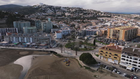 sweeping aerial establishing over beachfront community in peniscola near playa sur coastline