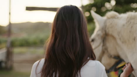 woman walking with her horse