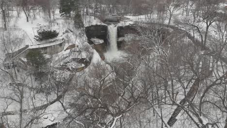 aerial footage of a winter landscape revealing a waterfall, minnesota, minehaha, cloudy