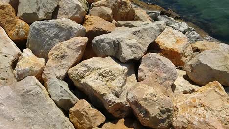 summer daytime view at big rocks near calm sea