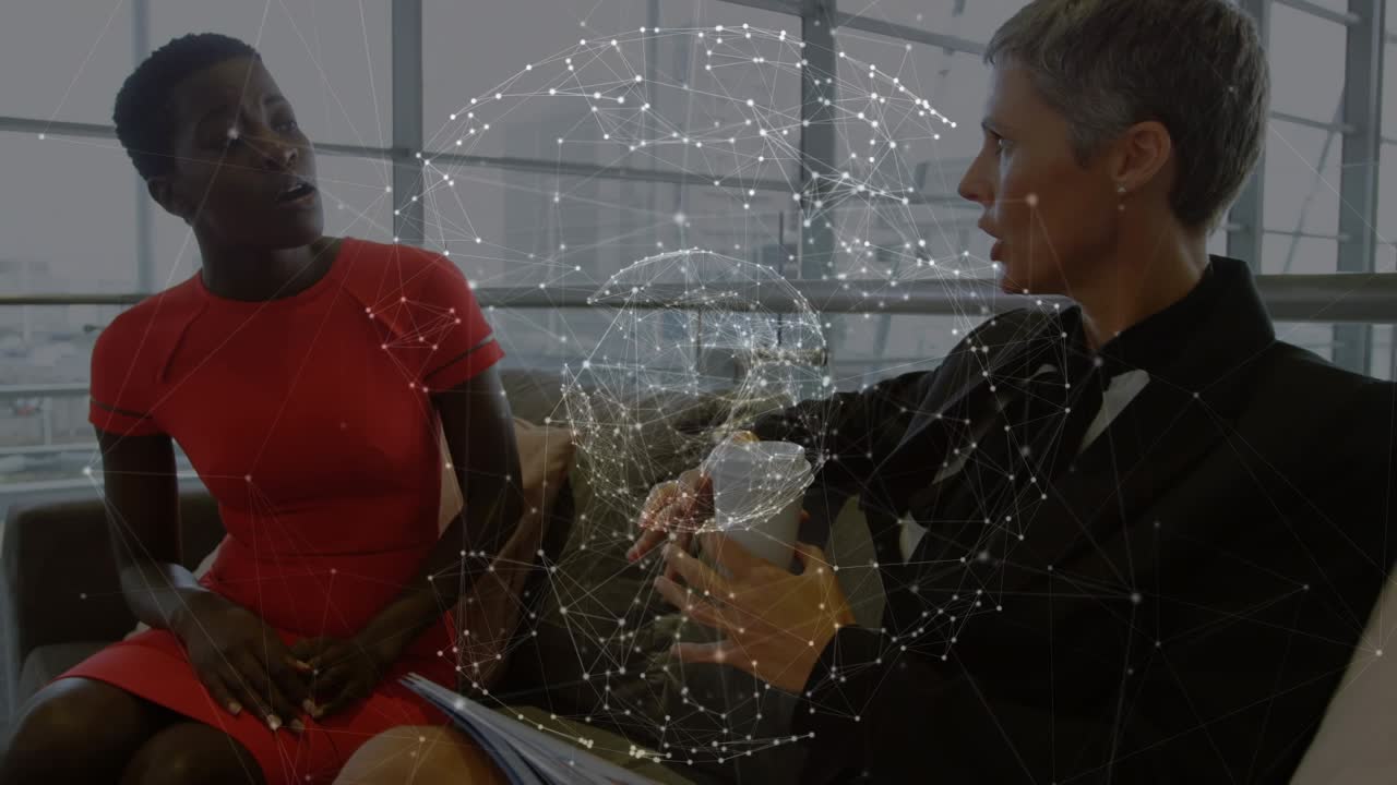 Animation of connections and globe over diverse businesswomen talking
