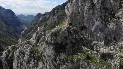 aerial rising next to rock wall, lake bovilla, albania