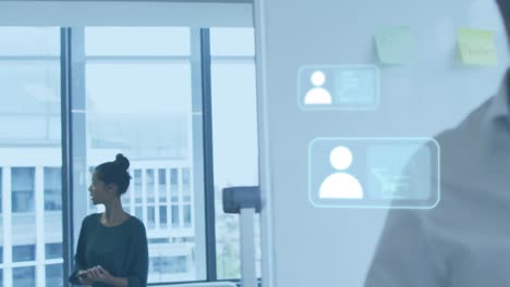 animation of profile icons, computer language over diverse coworker walking and discussing in office
