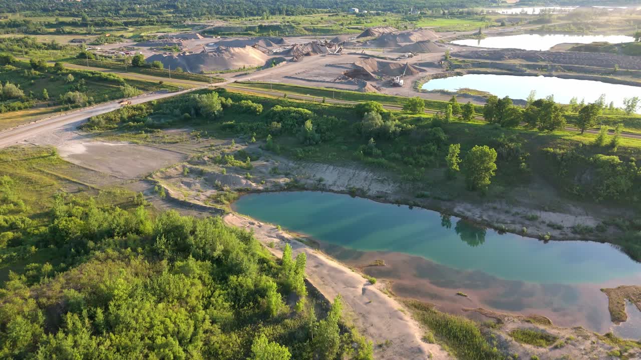 Aerial of gravel pit quarry with dump truck driving to excavation area