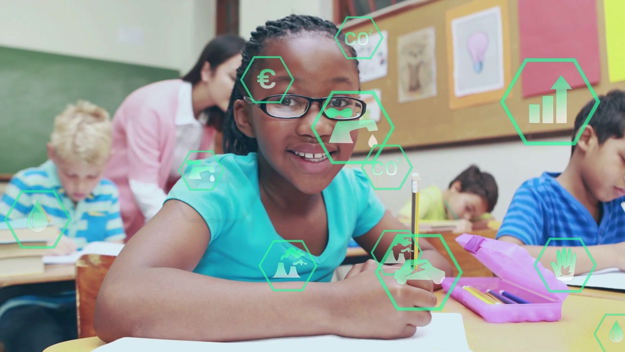 Front girl writing, teacher walking and leaning in checking work in classroom, hex icons overlaying