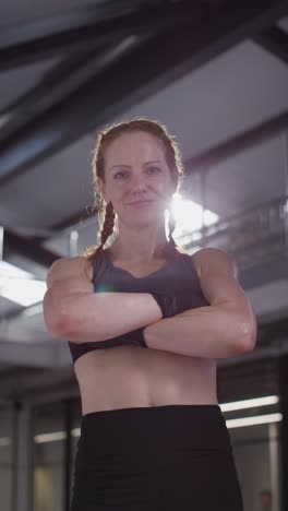 Vertical-Video-Portrait-Of-Smiling-Mature-Woman-Wearing-Fitness-Clothing-Standing-In-Gym-Ready-To-Exercise-2