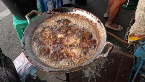 cooking traditional snacks in bubbling hot oil