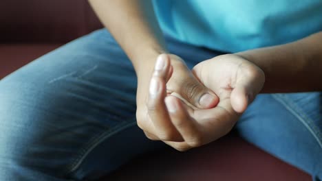 man suffering pain in hand close up