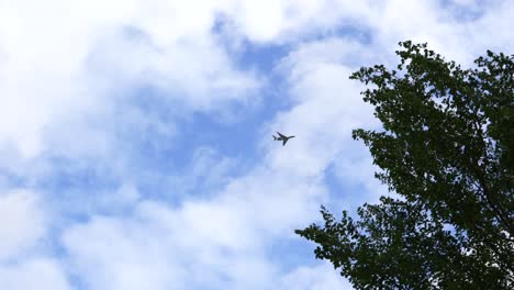 an airplane flies over the camera at low altitude in fine weather