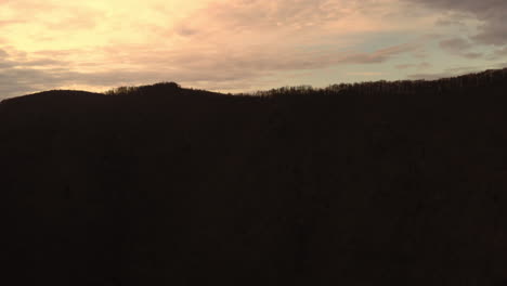 silhouetted tarnita lake and surrounding hills at sunset with cloud movement