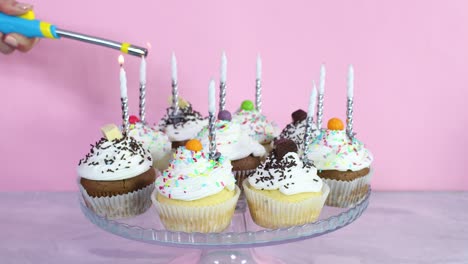 lighting up candles on cup cakes for birthday party