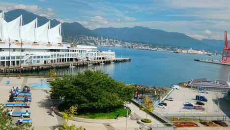 Canada-Place-And-Waterfront-Station-SeaBus-Terminal-In-Vancouver,-BC-With-People-And-Boats-In-Motion-On-A-Sunny-Day