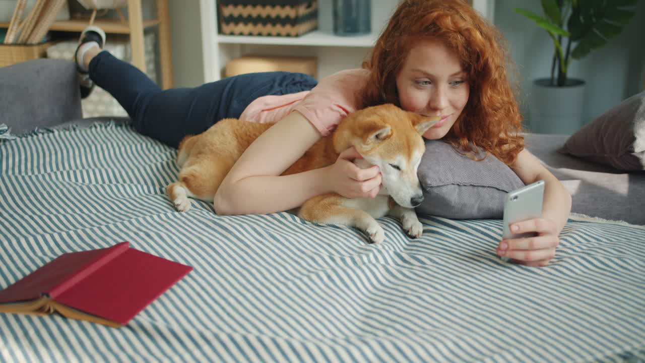 Woman relaxing with her dog on the bed