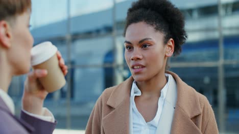 two women in conversation at an airport