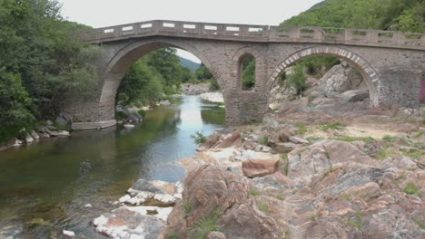 aerial 4k shot of old stone bridge and river pilima xanthi greece-2