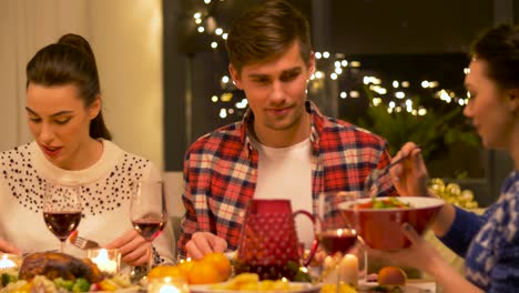 Feiertage-Und-Festkonzept-Glückliche-Freunde,-Die-Zu-Hause-Weihnachtsessen-Haben-Und-Essen