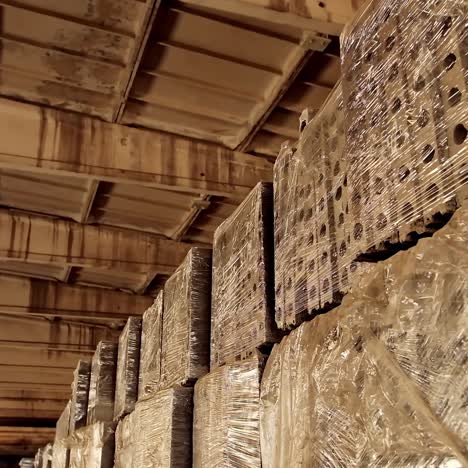 Interior of reinforced concrete plant. Pile of stocked concrete slabs in the building. Packed concrete blocks in workshop. Industry of building materials.