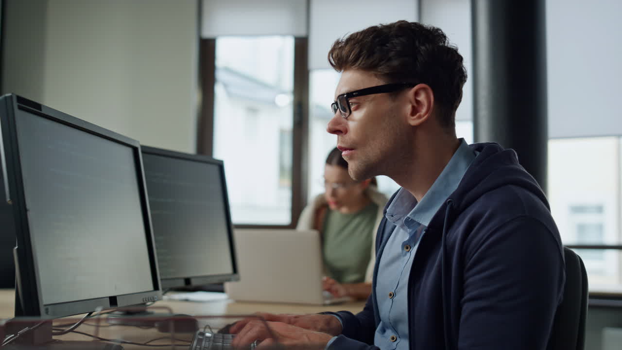 ingeniero de software trabajando en una oficina. hombre enfocado desarrollador escribiendo computadora de escritorio