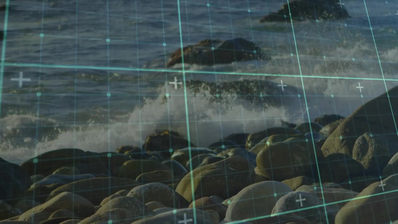 Waves rolling in and foam spilling over rocky shore under crosshair grid overlay visualizing motion