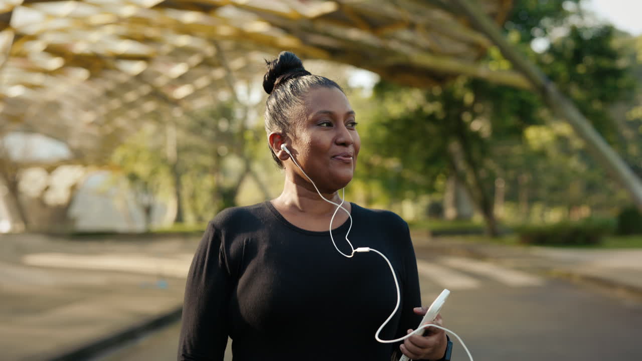 Woman jogging in the park with headphones