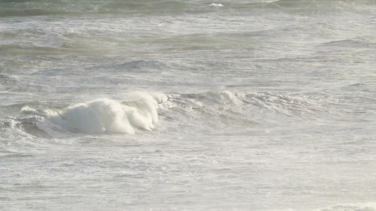 Soft waves ripple and flow across the ocean, creating a calming and rhythmic visual experience.