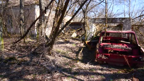 Broken-old-red-metal-car,-radiation-Chernobyl-village