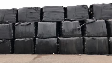 bales waste wrapped in black plastic