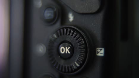 Macro-shot-of-a-DSLR-camera,-menu-buttons-close-up,-studio-lighting,-photography-gear,-slow-motion-120-fps,-Full-HD-video,-slide-up-movement