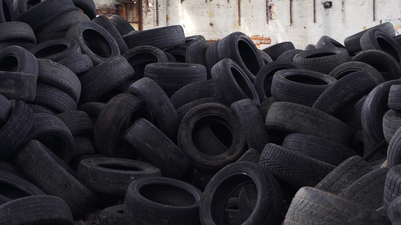 Old tires at a dump, close up. Pile of used tires lays at a special dump