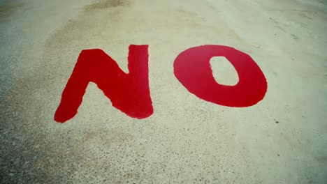 red "no" sign painted on concrete