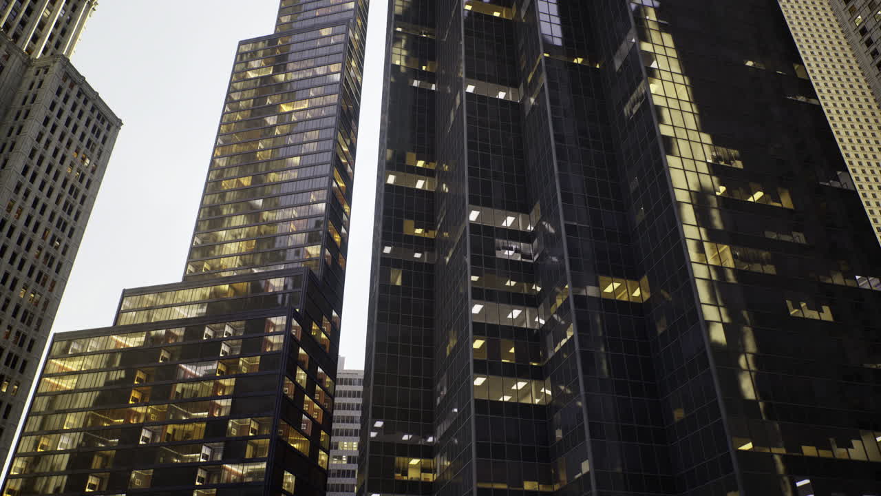 Modern urban buildings illuminated at dusk in a bustling city