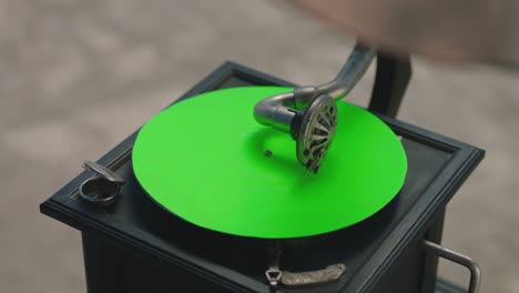 vintage gramophone . vintage old gramophone plays a vinyl record on green screen background . wooden case turntable . vinyl phonograph . shot on arri alexa cinema camera in slow motion .