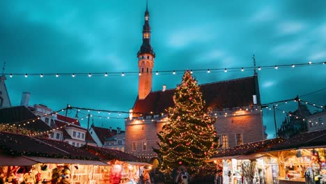 tallinn, estonia. timelapse time-lapse of traditional christmas market in town hall square. christmas tree and trading houses. famous landmark unesco
