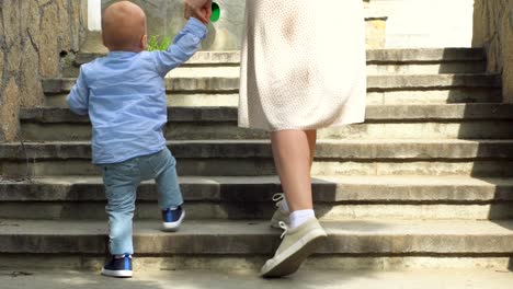 mother and child walking up stone stairs