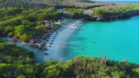 slow drone push in above grote knip or playa kenapa beach bungalows with amenities