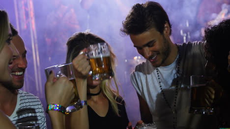 group of friends toasting beer mugs at a concert 4k