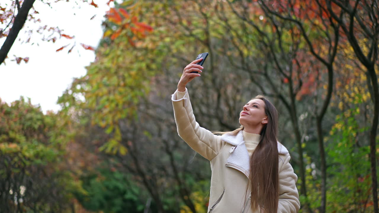 Woman Taking a Selfie in Autumn Park