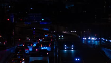 a night timelapse of the traffic jam at the city street in tokyo long shot