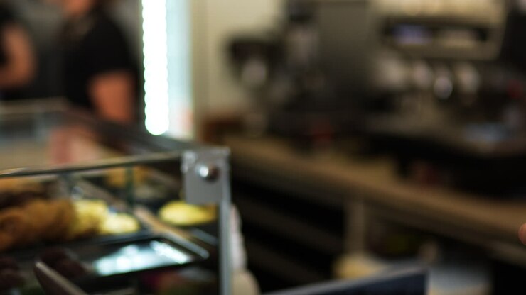 Waitress giving take away coffee to woman